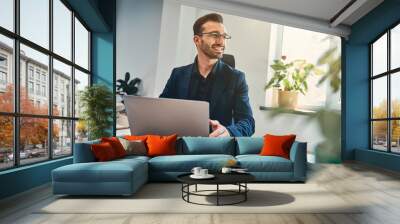 Handsome project manager with laptop in the cabinet Wall mural