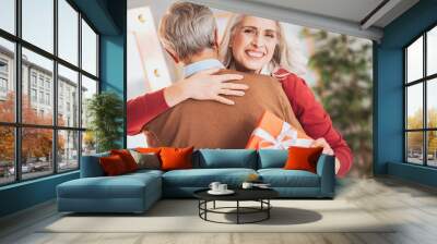 Keep smiling. Joyful mature woman embracing her man while posing on camera Wall mural