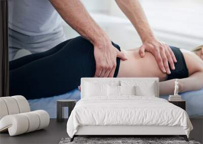 Male physiotherapist doing professional manual therapy session in medical office Wall mural