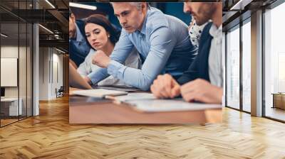 Mature Businessman having business meeting with young European startup team in modern office Wall mural