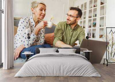 Pleased astrologer looking at his female client Wall mural