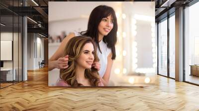 Positive professional hairdresser working on the salon  Wall mural