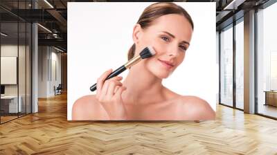 Pretty young woman holding makeup brush Wall mural