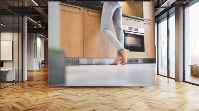 Slim Caucasian female cook at the countertop Wall mural