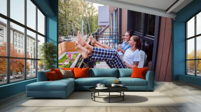 Start of the day. Joyful happy couple sitting on the balcony while enjoying their morning Wall mural