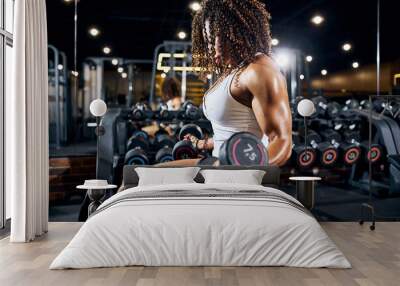 Well-built young bodybuilder doing the strength workout Wall mural