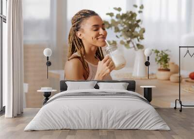 Woman after finishing workout drinking protein shake Wall mural