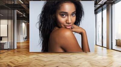 Young Afro-American woman is posing in studio Wall mural