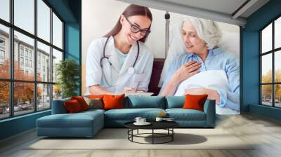 Young doctor with patient Wall mural