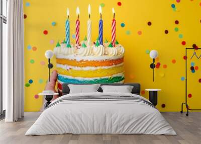 Colorful birthday cake with lit candles on a vibrant background Wall mural