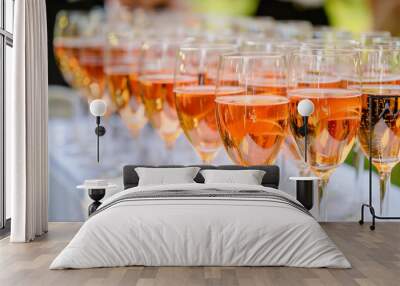 Elegant sparkling rose wine in glasses at a festive event Wall mural