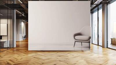 A minimalist corner of a living room featuring a single sleek, modern armchair. The background is a simple white wall, and the room is free of clutter, creating a calm and open space Wall mural