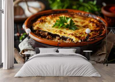 Greek moussaka, featuring layers of eggplant, ground beef, and béchamel sauce, garnished with fresh parsley, served in a rustic clay dish on a linen-covered table Wall mural