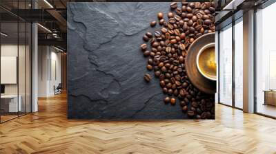 A flat lay composition of a cup of aromatic coffee and roasted coffee beans on a dark stone table with copy space Wall mural