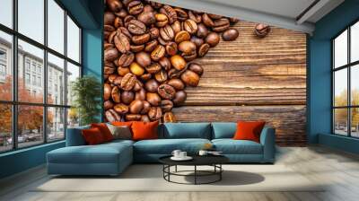 Close-up of freshly roasted organic coffee beans on a rustic wooden surface Wall mural