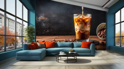 Iced coffee pouring onto dark table, with copy space Wall mural