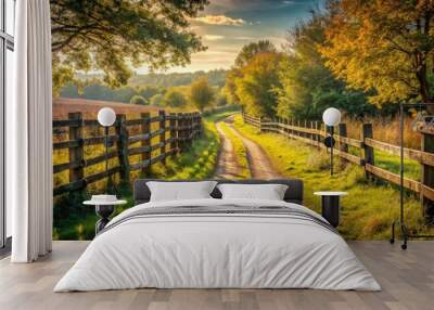 Rustic wooden fence along a winding rural path in the countryside Wall mural