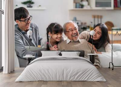 Happy multigenerational asian family portrait in living room Wall mural