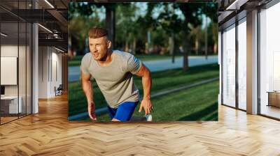 athletic man in the park workout jogging exercise summer Wall mural