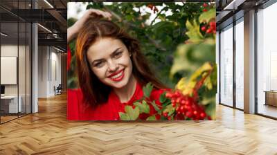 beautiful woman bush with berries nature fresh air Wall mural