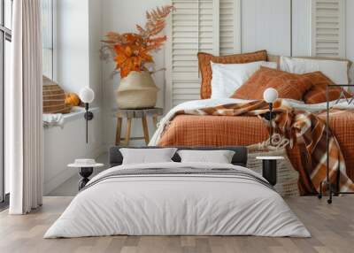 Cozy bedroom with warm autumn decor and orange bedding, featuring stylish pillows and a decorative basket Wall mural