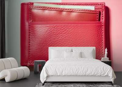 Travel essentials red leather wallet with credit card on pink and blue background Wall mural