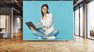 woman with laptop learning internet online education blue background Wall mural