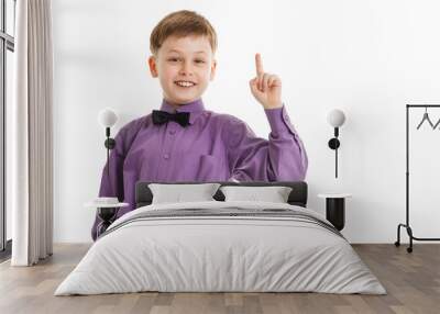 Young boy with a bow-tie showing thumb up isolated Wall mural