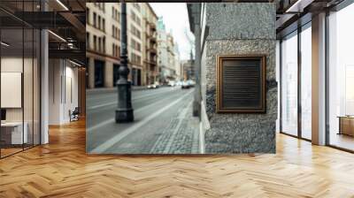 A historic plaque on a textured stone wall captures the essence of an old city street, blending history with urban life. Wall mural