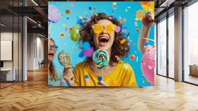 A lively celebration with colorful confetti and girls enjoying lollipops and balloons, capturing the essence of fun and excitement. Wall mural