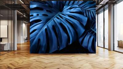 deep blue tropical leaves in a moody dramatic arrangement featuring monstera and palm leaves in a rich dark color palette evoking a sense of mystery and exotic beauty Wall mural