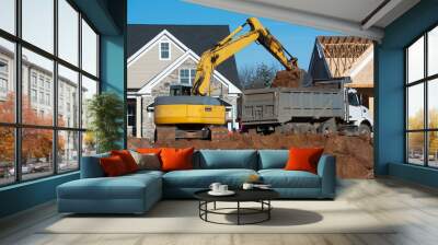 excavator digs a foundation pit for a new house Wall mural