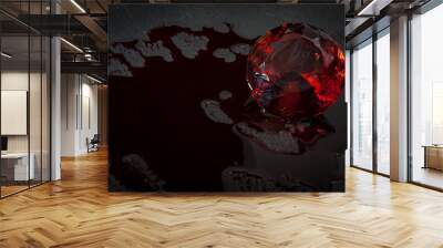 Blood diamond concept with a diamond covered in red blood in a dark setting resembling a mine with copy space Wall mural