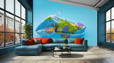 Global warming, climate catastrophe and environmental trouble concept with deflated globe isolated on blue background Wall mural