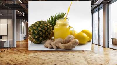 Juicing raw fruits and vegetables and juice extractor recipes concept with pineapple, lemon and ginger, the ingredients for a detox smoothie that helps with inflammation and digestion Wall mural