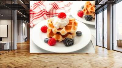 Wholesome breakfast, healthy dessert and waffle snack concept theme with a  plate of belgian waffles with blueberries, blackberries, raspberries and whipped cream on a rustic white wooden table Wall mural