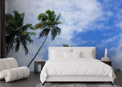 palm trees against blue sky Wall mural