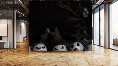 HALLOWEEN, GOLF BALLS DECORATED LIKE PUMPKINS WITH TERRORIFIC FACES WITH CANDLES, FOLIAGE, CROSSES, INSECTS ON RUSTIC WOODEN TABLE AND DARK BACKGROUND WITH SPACE FOR TEXT Wall mural