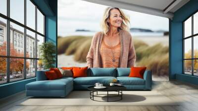 Portrait in the beach of a pleased 50 years old woman.  Wall mural