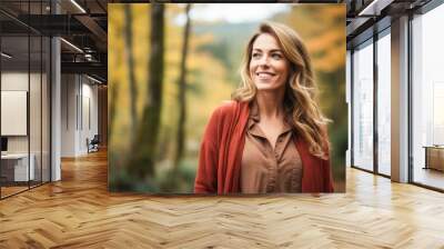 Portrait in the forest of a pleased 30 years old woman. Joyful woman in an  outdoor fall scenery having fun at the autumn season.  Wall mural