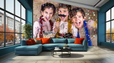 Thre happy kids celebrating new year eve at home Wall mural