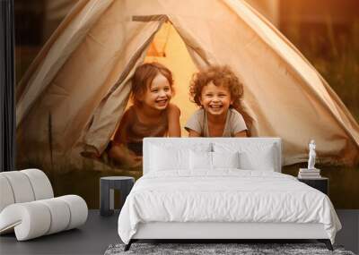 Two funny children smiling in front of a tent Wall mural