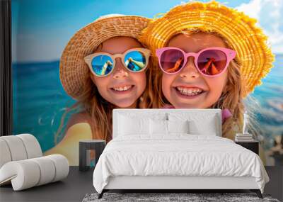 Two girls with straw hats and sunglasses taking a selfie on a summer day near the beach Wall mural