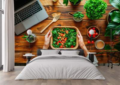 Woman holding a salad inside recyclable cardboard at her workplace Wall mural