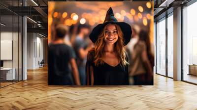 Young woman dressed as a witch at a Halloween party Wall mural