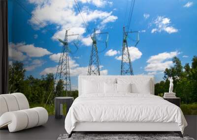 High voltage lines in a forest clearing on a Sunny day with feathery clouds in the blue sky. Wall mural