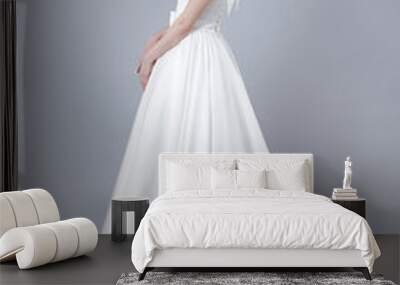 Fashion bride woman posing in wedding dress isolated on gray bac Wall mural