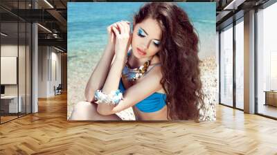 Healthy Long Hair. Beautiful girl on the beach posing near sea w Wall mural