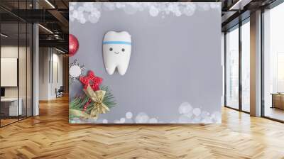 banner for dentistry for Christmas and New Year with tooth model on gray background with Christmas decor with copy space. Wall mural