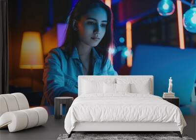 beautiful young female hacker programmer sitting at a laptop Wall mural